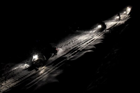 Snowmobile tour in dark Golden evening snowmobile tours golden bc